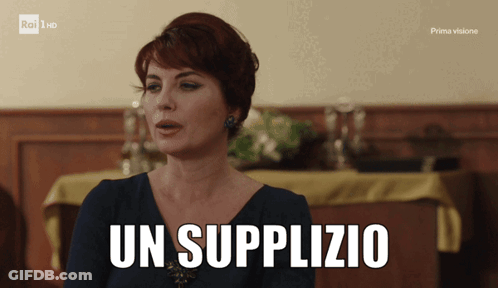 A Woman Is Sitting In Front Of A Table With The Words Un Supplyzio Written On It GIF