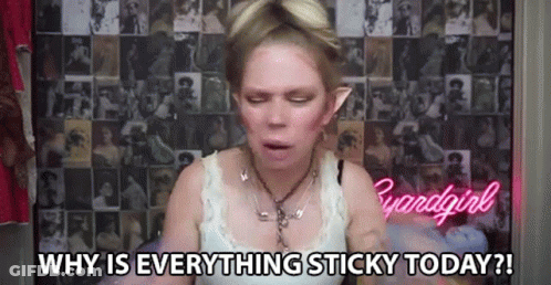 A Woman Is Sitting In Front Of A Wall With A Collage Of Pictures And Says `` Why Is Everything Sticky Today ? '' GIF