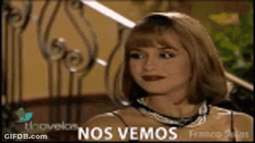 A Woman Is Sitting In Front Of A Wrought Iron Railing With The Words Nos Vemos On The Bottom GIF