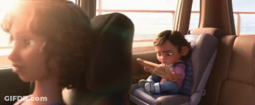 A Woman Is Sitting In The Back Seat Of A Car With A Baby In A Car Seat . GIF