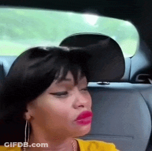 A Woman Is Sitting In The Back Seat Of A Car With Her Eyes Closed GIF