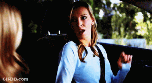 A Woman Is Sitting In The Back Seat Of A Car With Her Mouth Open . GIF