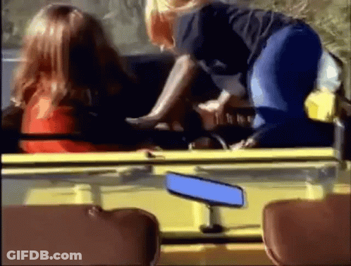 A Woman Is Sitting In The Back Seat Of A Yellow Car . GIF