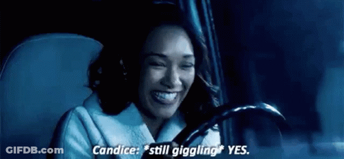 A Woman Is Sitting In The Driver 'S Seat Of A Car . GIF