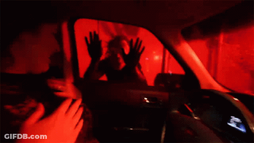 A Woman Is Sitting In The Driver 'S Seat Of A Ford Car . GIF