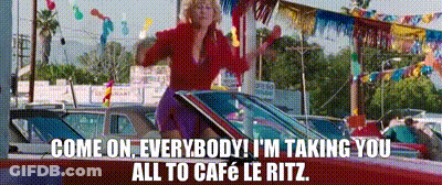 A Woman Is Sitting In The Driver 'S Seat Of A Red Car And Talking On A Cell Phone . GIF