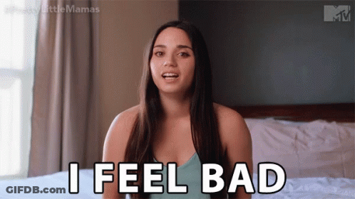 A Woman Is Sitting On A Bed And Saying " I Feel Bad " GIF