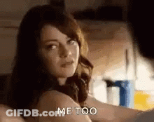 A Woman Is Sitting On A Bed Talking To A Man . GIF