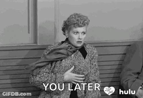 A Woman Is Sitting On A Bench With Her Hands On Her Chest . GIF