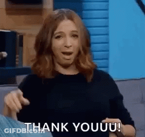A Woman Is Sitting On A Couch And Giving A Thank You Gesture . GIF