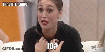 A Woman Is Sitting On A Couch And Making A Funny Face While Holding Her Hair . GIF