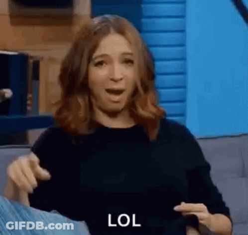 Woman Sitting On Couch Making Funny Face Pointing GIF