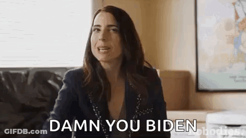 A Woman Is Sitting On A Couch And Saying `` Damn You Biden '' While Looking At The Camera . GIF
