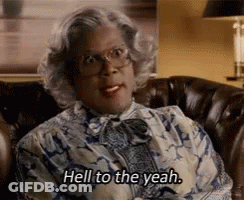 A Woman Is Sitting On A Couch And Saying `` Hell To The Yeah . '' GIF