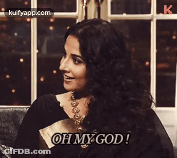 A Woman Is Sitting On A Couch And Says Oh My God GIF