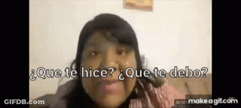 A Woman Is Sitting On A Couch And Smiling With The Words Que Te Hice Que Te Debo Behind Her . GIF