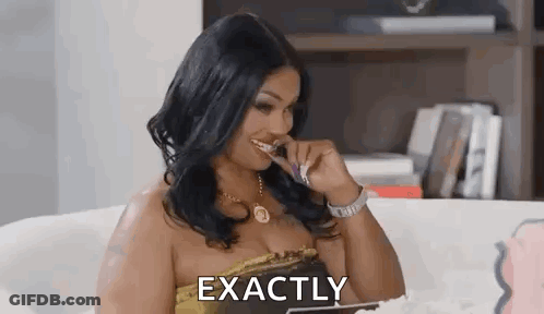 A Woman Is Sitting On A Couch Brushing Her Teeth With A Toothbrush . GIF