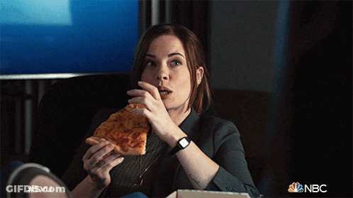 A Woman Is Sitting On A Couch Eating A Slice Of Pizza With A Nbc Logo In The Background GIF