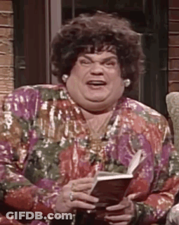 A Woman Is Sitting On A Couch Holding A Book And Making A Funny Face . GIF