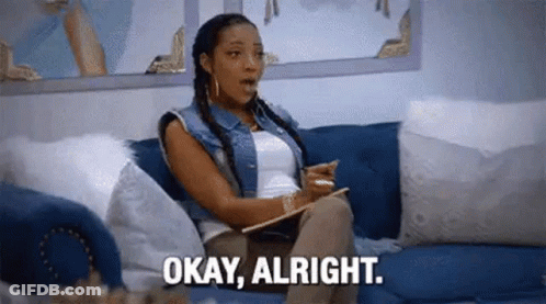 A Woman Is Sitting On A Couch Holding A Clipboard And Saying `` Okay , Alright '' . GIF