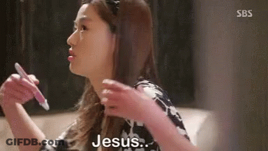 A Woman Is Sitting On A Couch Holding A Pen In Her Hand And Saying Jesus . GIF