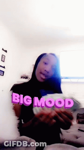 Woman Sitting On Couch Holding Big Mood Paper GIF