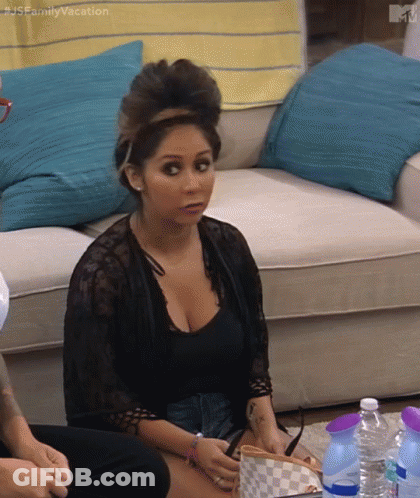 A Woman Is Sitting On A Couch In A Living Room With Bottles Of Water . GIF