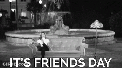 A Woman Is Sitting On A Couch In Front Of A Fountain With The Words `` It 'S Friends Day '' . GIF