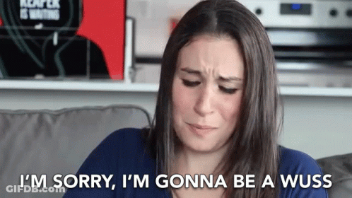 A Woman Is Sitting On A Couch Saying I 'M Sorry GIF