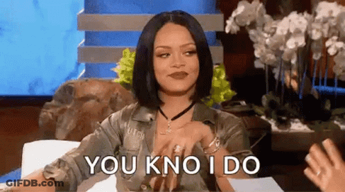 A Woman Is Sitting On A Couch Talking To Another Woman While Holding Her Hand To Her Chest . GIF