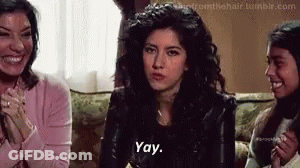 A Woman Is Sitting On A Couch Talking To Two Other Women . GIF