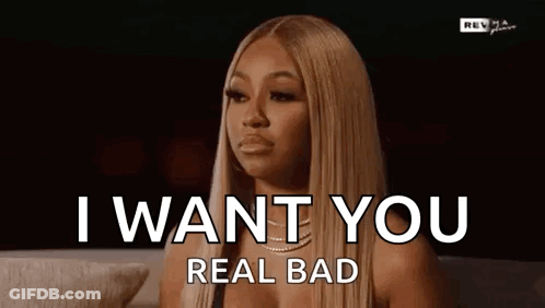 A Woman Is Sitting On A Couch With Her Eyes Closed And Says `` I Want You Real Bad '' . GIF