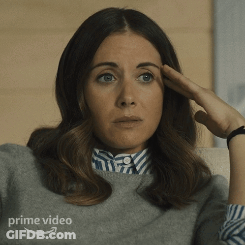 A Woman Is Sitting On A Couch With Her Hand On Her Forehead And The Word Prime Video Is On The Bottom GIF