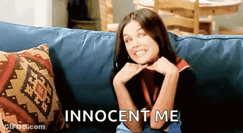 A Woman Is Sitting On A Couch With Her Hands On Her Chin And The Words Innocent Me Written On The Bottom . GIF