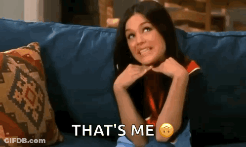 A Woman Is Sitting On A Couch With Her Hands On Her Chin And The Words `` That 'S Me '' . GIF