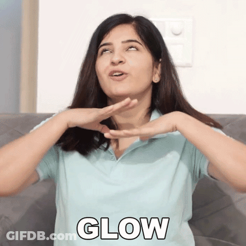A Woman Is Sitting On A Couch With Her Hands On Her Face And The Word Glow In Front Of Her GIF