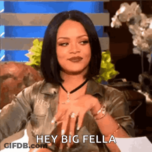 A Woman Is Sitting On A Couch With Her Hands On Her Hips And Says Hey Big Fella . GIF