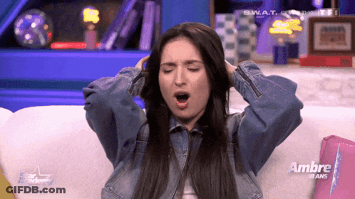 Woman Sitting On Couch With Ambre Sign GIF