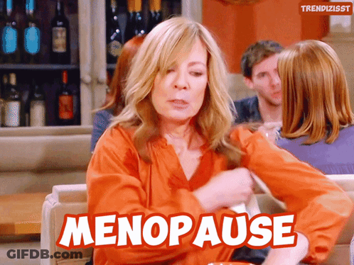 A Woman Is Sitting On A Couch With The Word Menopause Written On It GIF