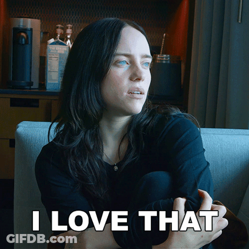 A Woman Is Sitting On A Couch With The Words " I Love That " Behind Her GIF