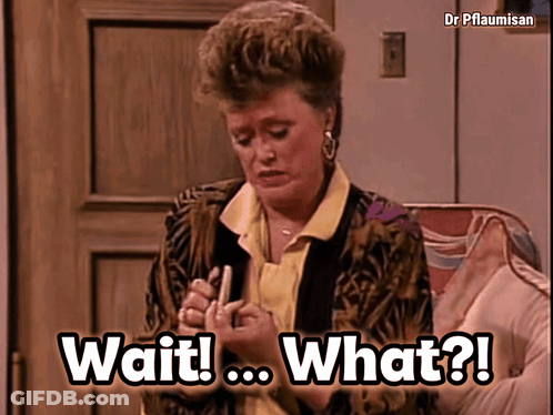 A Woman Is Sitting On A Couch With The Words Wait What Written On The Screen GIF