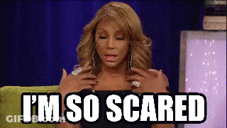 A Woman Is Sitting On A Green Couch With Her Hands On Her Chest And The Words `` I 'M So Scared '' . GIF