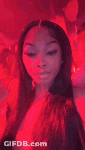 A Woman Is Sitting On A Man 'S Shoulder At A Party And Making A Funny Face . GIF