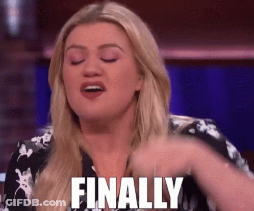 A Woman Is Sitting On A Stage With Her Eyes Closed And Says Finally . GIF