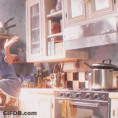 A Woman Is Sitting On A Stool In A Kitchen With A Pot On The Stove GIF