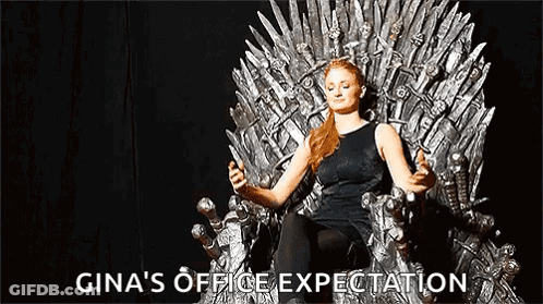 A Woman Is Sitting On A Throne Holding A Sword And A Cell Phone . GIF