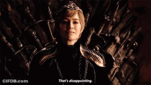 A Woman Is Sitting On A Throne With A Crown On Her Head And Smiling . GIF