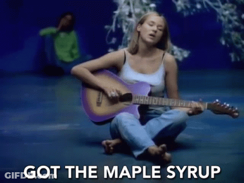 A Woman Is Sitting On The Floor Playing A Purple Guitar And Singing . GIF
