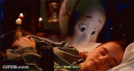 A Woman Is Sleeping In A Bed With A Stuffed Animal Behind Her . GIF