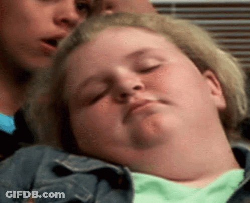 A Woman Is Sleeping With Her Eyes Closed While Another Woman Looks On . GIF